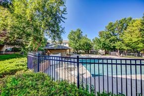 Fort Collins apartment for rent - a fenced in swimming pool with a gazebo and trees