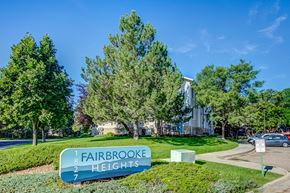 Fort Collins apartment for rent - a view of fairbrooke heights apartments with trees and a sign