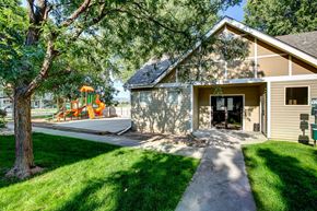 Fort Collins apartment for rent - the front of a house with a yard and a playground