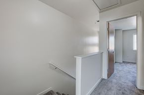 Fort Collins townhouse for rent - an empty room with a hallway and a door to a bedroom