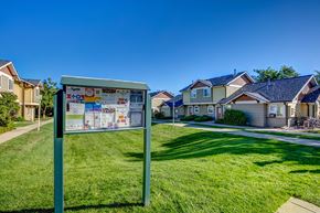 Fort Collins townhouse for rent - a sign in the grass in front of some houses