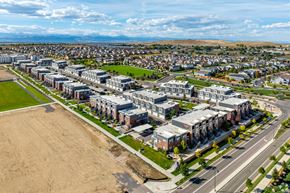 Broomfield townhouse for rent - A large, modern rental townhome complex is situated in a green, grassy area.