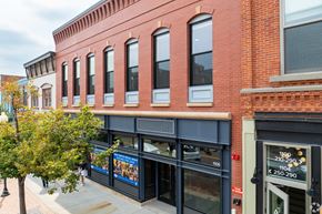 Golden apartment for rent - A red brick building with a blue awning and a sign that reads 1106.