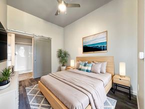 Des Moines apartment for rent - A bedroom with a bed, nightstand, and a painting on the wall.