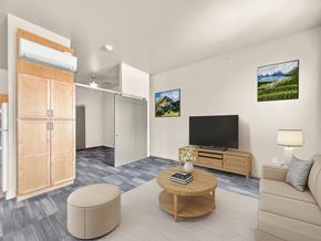 Des Moines apartment for rent - A modern living room with a flat screen TV and a wooden coffee table.