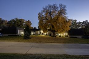 Des Moines townhouse for rent - A house with a tree in front of it.