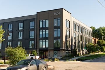 Des Moines apartment for rent - A grey car is parked in front of a building with the number 1601 on it.