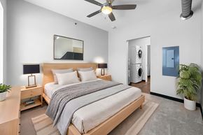 Des Moines apartment for rent - A bedroom with a bed, nightstand, and a ceiling fan.