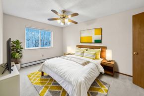 Des Moines apartment for rent - A bedroom with a bed, a ceiling fan, and a window.