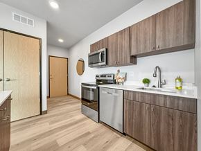 Des Moines apartment for rent - a kitchen with stainless steel appliances and wooden cabinets