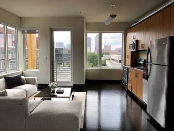 Des Moines apartment for rent - A modern kitchen with a refrigerator, oven, and microwave.