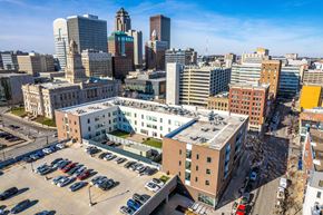 Des Moines apartment for rent - A cityscape with a large building in the foreground and several other buildings in the background.