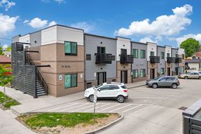Des Moines apartment for rent - A modern building with a parking lot in front.