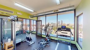 Des Moines apartment for rent - A gym with a view of the city skyline.