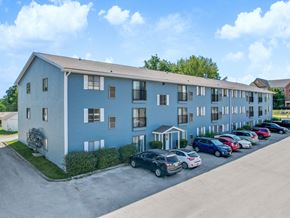Des Moines apartment for rent - A blue building with cars parked in front.