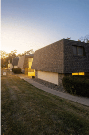 Des Moines townhouse for rent - A modern house with a dark roof and bright windows is shown.