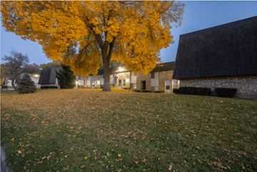 Des Moines townhouse for rent - A tree with yellow leaves is in front of a building.