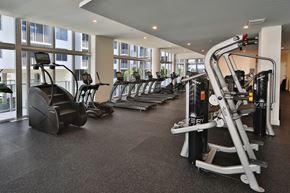 Dania Beach apartment for rent - A gym with a variety of equipment including treadmills, stationary bikes, and weight machines.