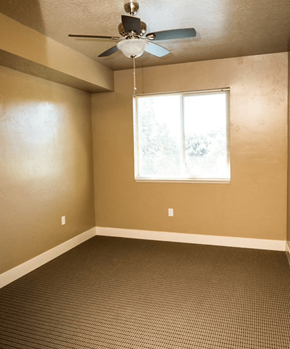 Nampa apartment for rent - bedroom room with a ceiling fan and a window