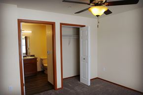 Evanston apartment for rent - Image showing toile and bathroom sink next to closet with hanger racks