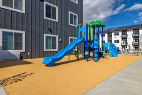 Helena apartment for rent - A playground with a blue slide and a green top.