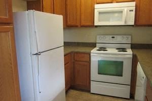Superior apartment for rent - a kitchen with white appliances and a refrigerator