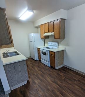 Seaside apartment for rent - Image of kitchen showing stove and refrigerator.