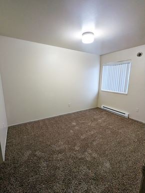 Seaside apartment for rent - Image of bedroom showing carpet and window with coverings.
