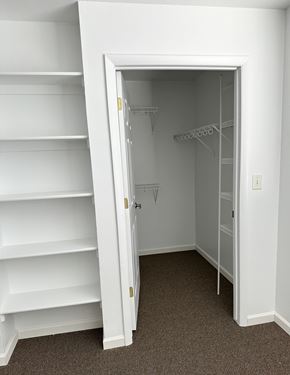 Evanston apartment for rent - A white closet with shelves and an open door.
