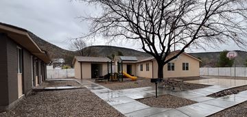 St. George apartment for rent - a playground in front of a house with a tree