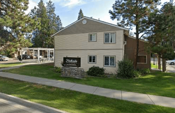 Post Falls apartment for rent - A building with a sign that says "Pinecrest" in front of it.