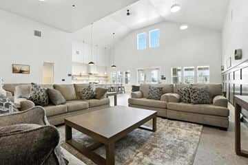 Caldwell apartment for rent - A spacious living room with a large sectional sofa and a coffee table.