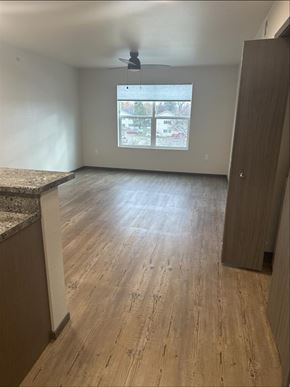 Hamilton apartment for rent - A room with wooden flooring and a ceiling fan.