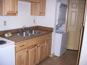 Superior apartment for rent - a kitchen with a sink and a refrigerator