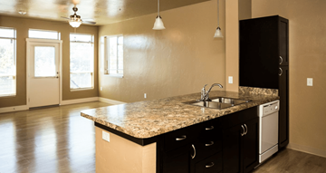 Nampa apartment for rent - A kitchen with a granite countertop and black cabinets.