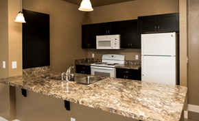 Nampa apartment for rent - a kitchen with a granite counter top and white appliances