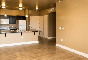 Nampa apartment for rent - A kitchen with a white fridge and a white door.