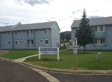 Kalispell apartment for rent - a sign in the grass in front of an apartment building