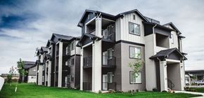 Caldwell apartment for rent - a view of the apartment complex with balconies and green grass