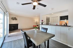 Westland apartment for rent - Open-concept living and dining area at Woodcrest Apartments in Westland, Michigan showcasing flexible floor space and contemporary design.