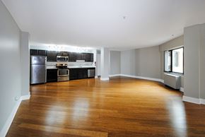Kalamazoo apartment for rent - A spacious kitchen with wooden floors and modern appliances in Kalamazoo, MI