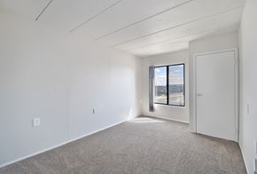 Southfield apartment for rent - A room with a carpeted floor and a window with a view of the outside.