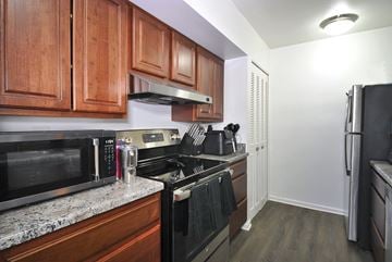 Westland apartment for rent - A kitchen with wooden cabinets and black appliances.
