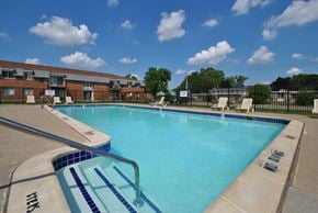 Warren apartment for rent - Outdoor swimming pool with sunchairs at Warren Woods Apartments in Warren, MI.
