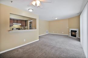 Westland apartment for rent - A spacious living room with a fireplace and a ceiling fan.