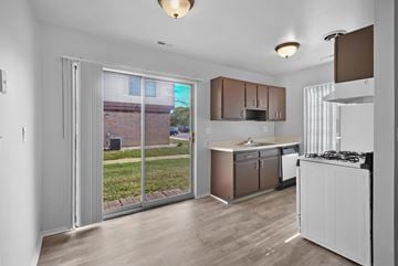Clinton Twp apartment for rent - A kitchen with white cabinets and a white stove top oven.