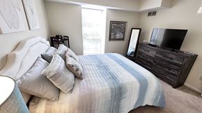 South Lyon apartment for rent - a bedroom with a large bed and a tv