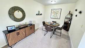 South Lyon apartment for rent - a dining room with a table and chairs and a wall mounted mirror