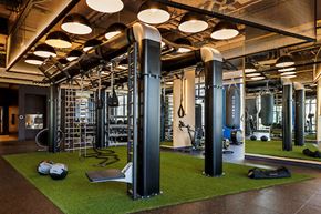 Jersey City apartment for rent - A gym with a variety of equipment including a weight machine, a ladder, and a bench.