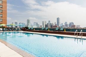Jersey City apartment for rent - A swimming pool with a city skyline in the background.